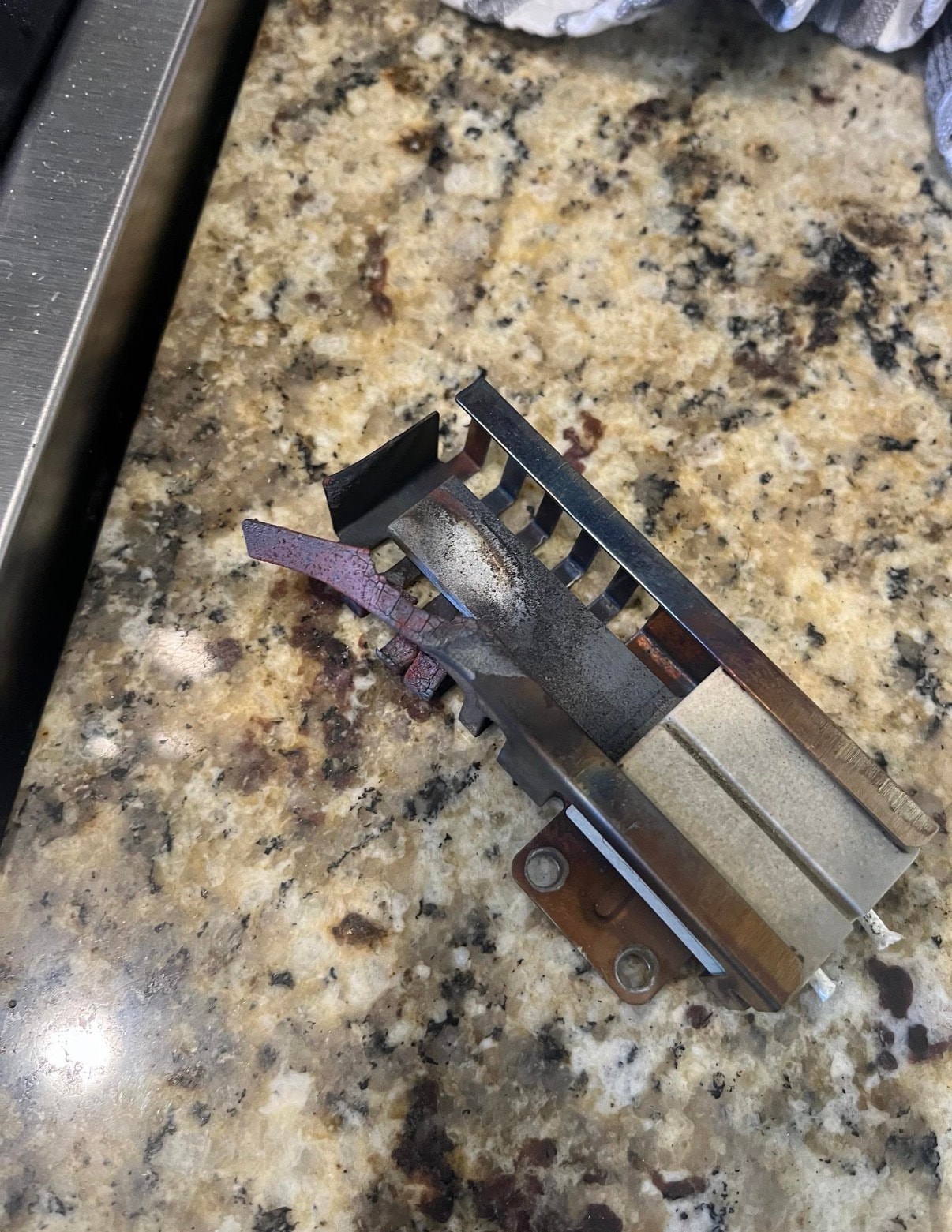 Failed Empava gas oven hot surface igniter removed — cracked ceramic element — Park Hill Denver repair