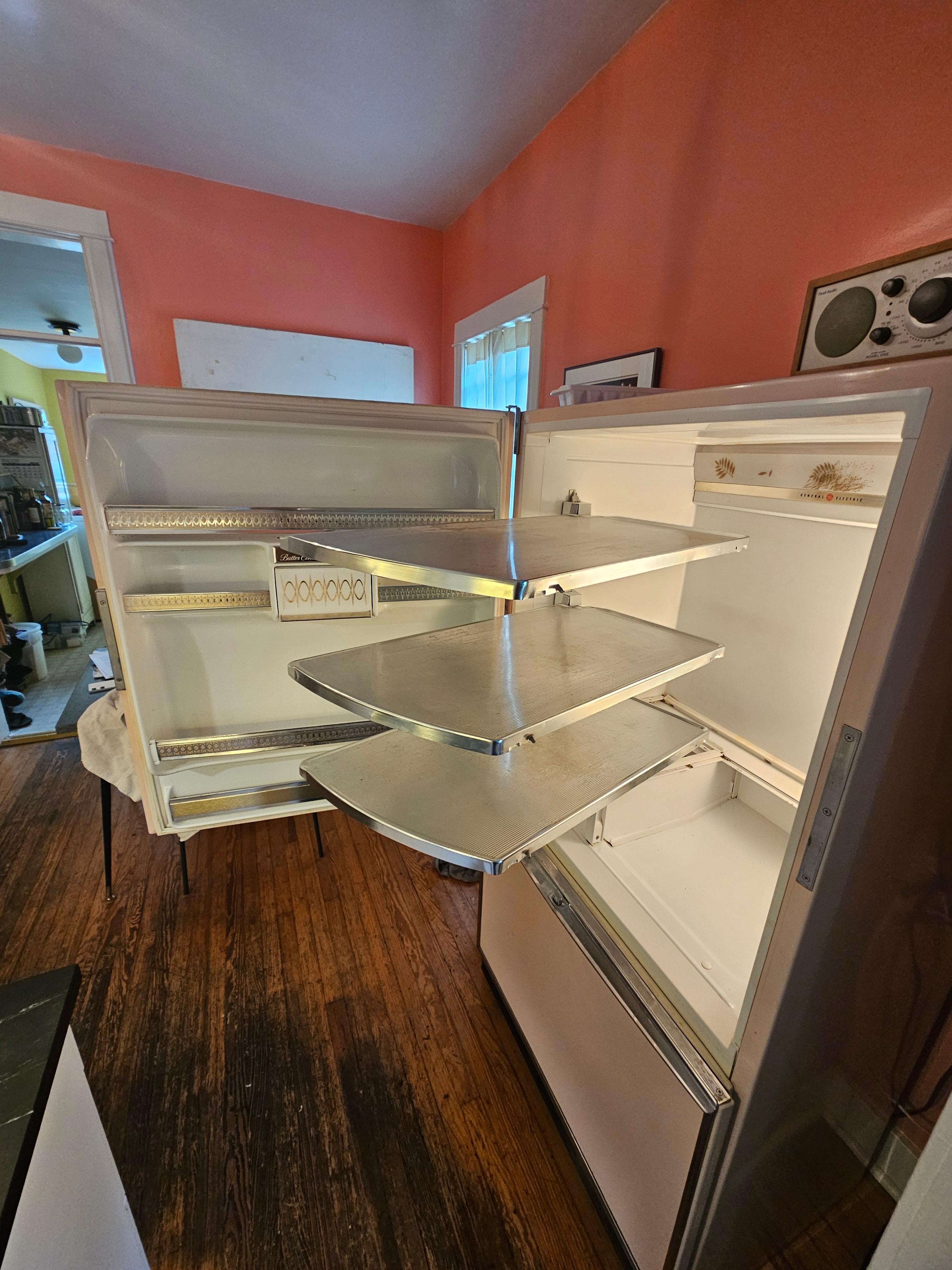 Vintage GE refrigerator interior open showing shelves and compartments — Highlands Denver