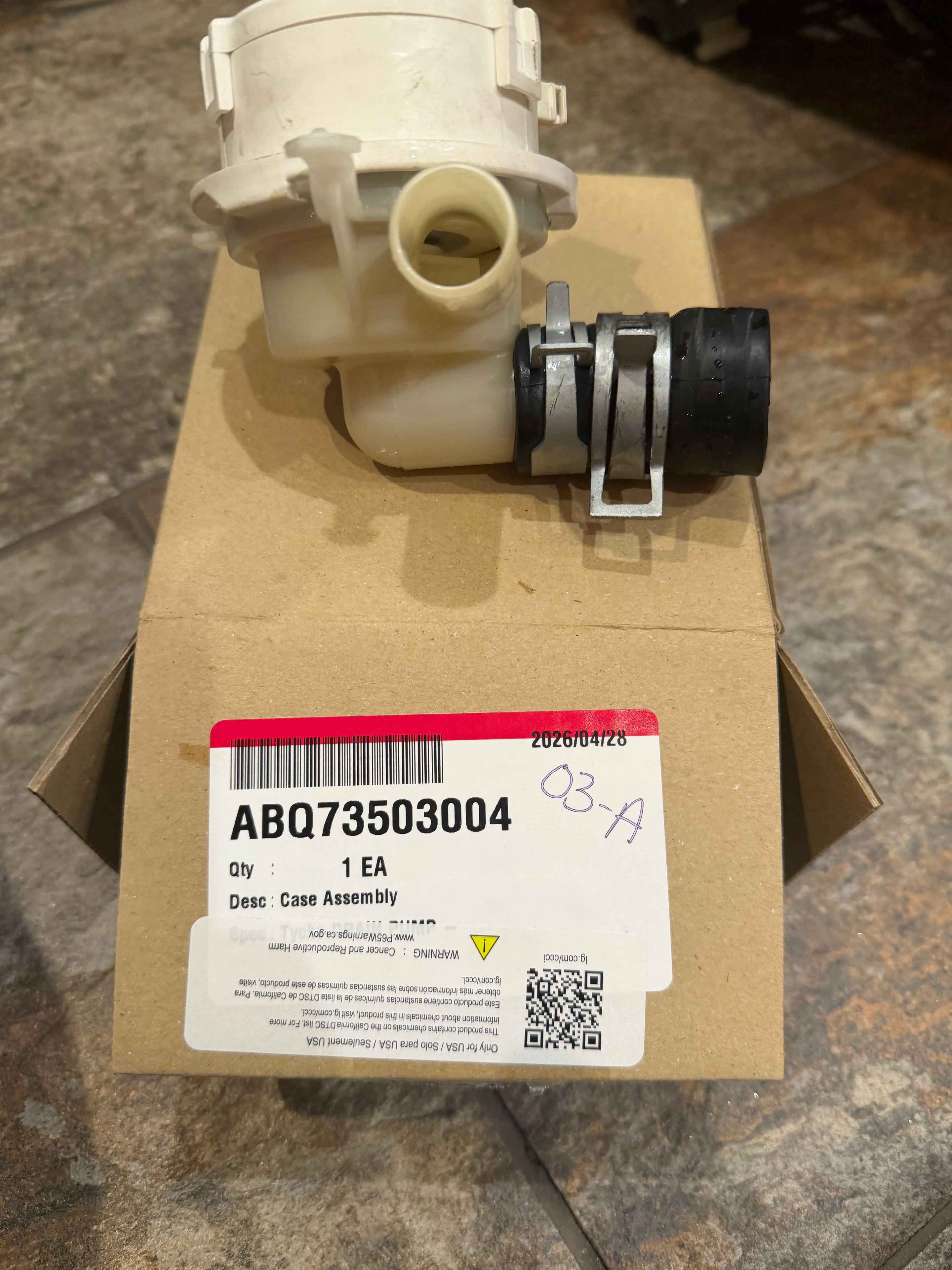 LG case assembly part ABQ73503004 in original packaging with part label showing drain pump assembly
