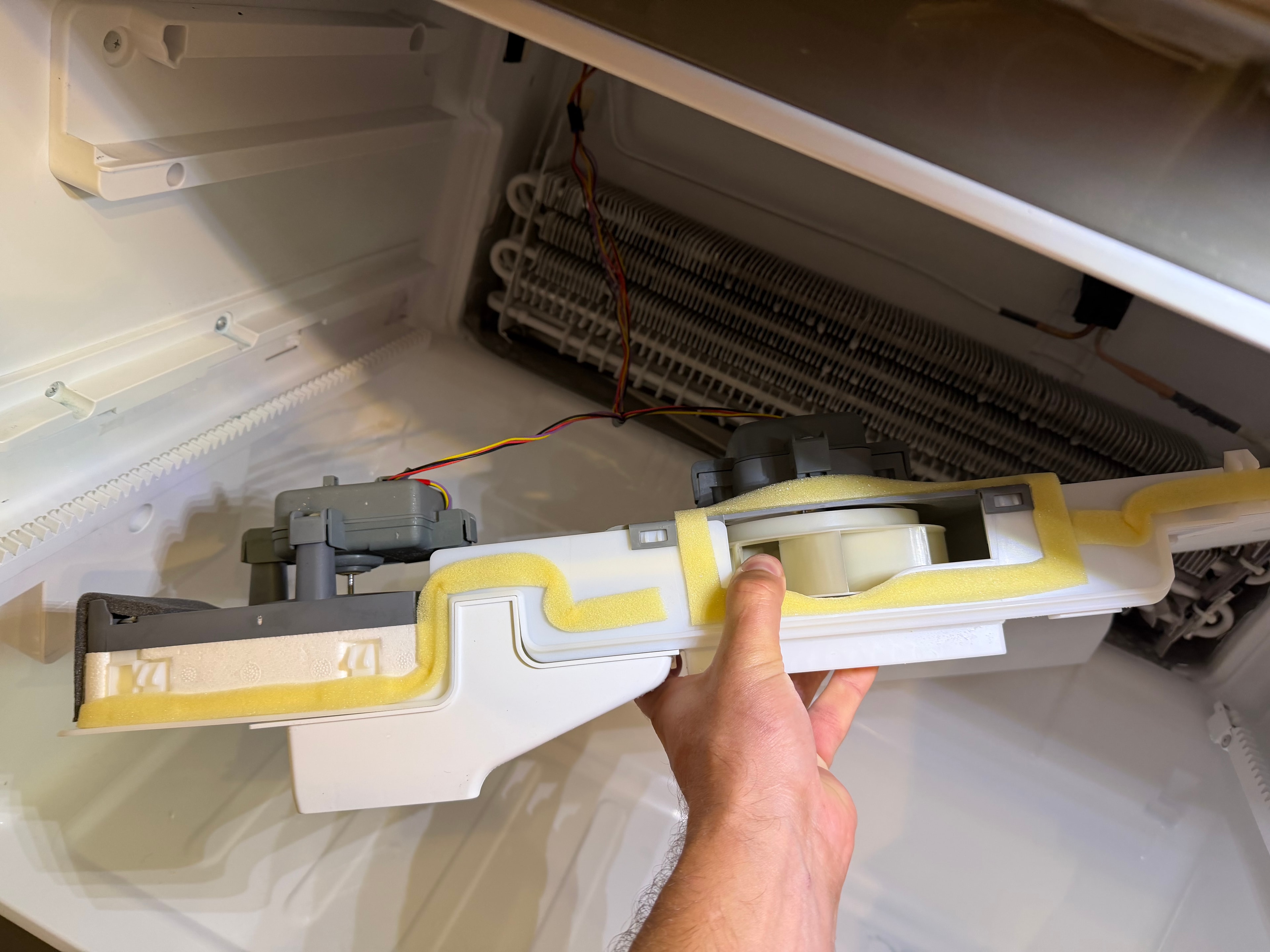 Ice room evaporator housing removed — fan motor assembly exposed for inspection