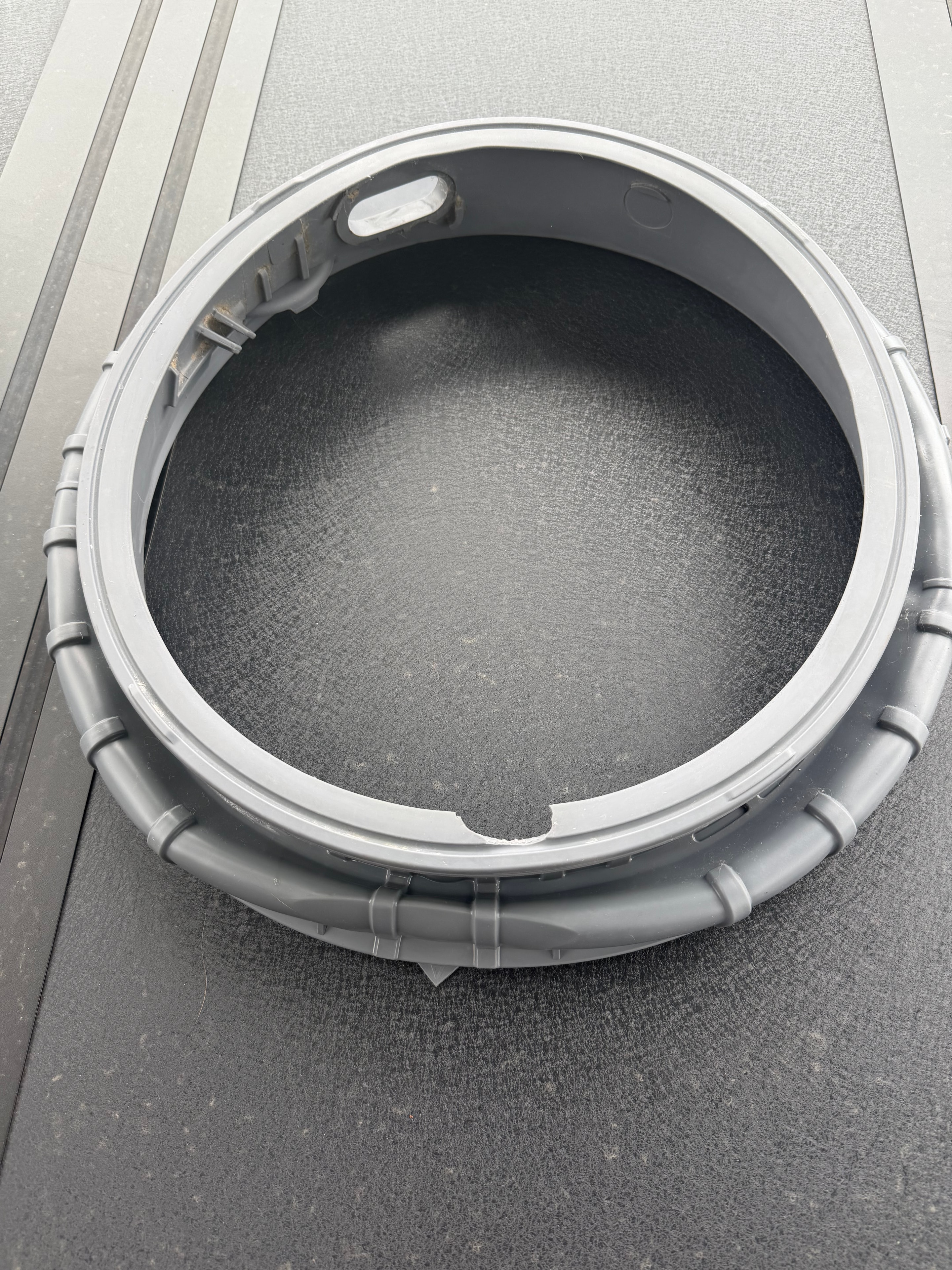 The torn door gasket (bellow) removed from the washer